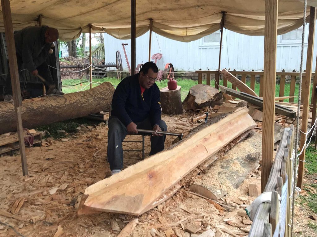 Unfinished canoe being built in wood and carved by a Marshallese community member
