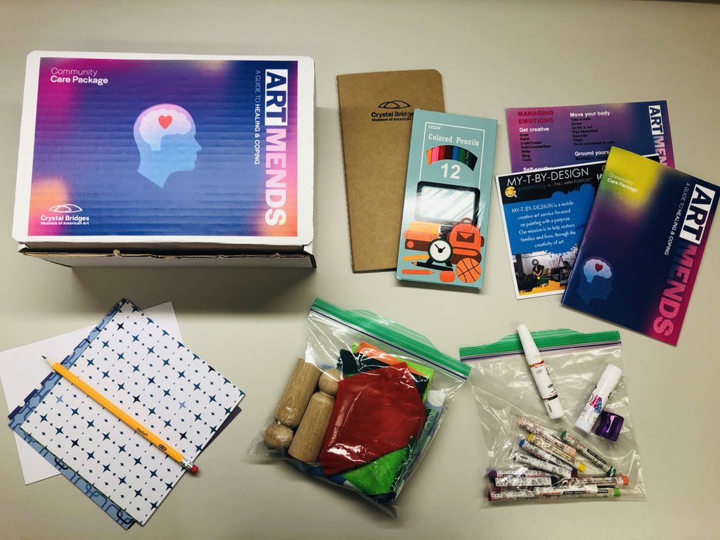 Art Mends package with notebook, colored pencils, booklet, cards, crayons, markers, crafting materials.
