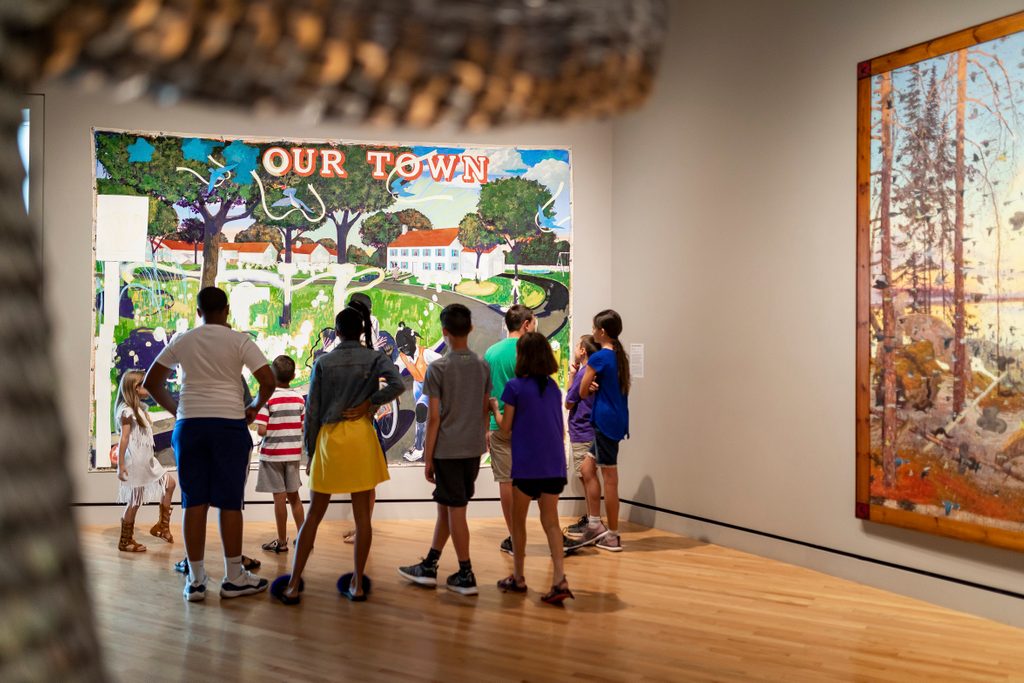 a group of elementary and middle school students look at Kerry James Marshall's Our Town in the contemporary art gallery