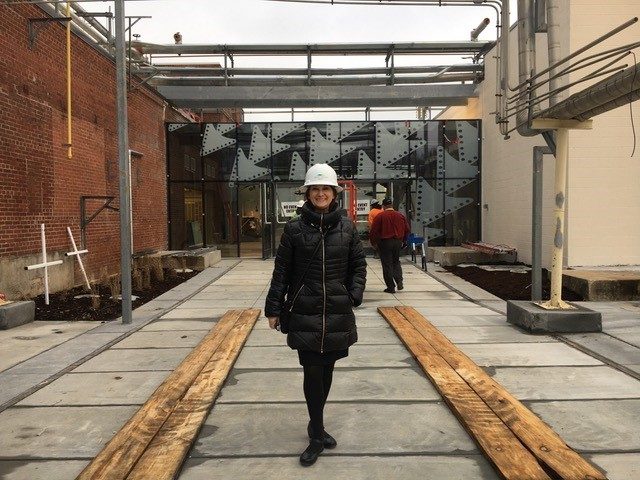 Staff member with a hard hat in front of the Momentary before opening