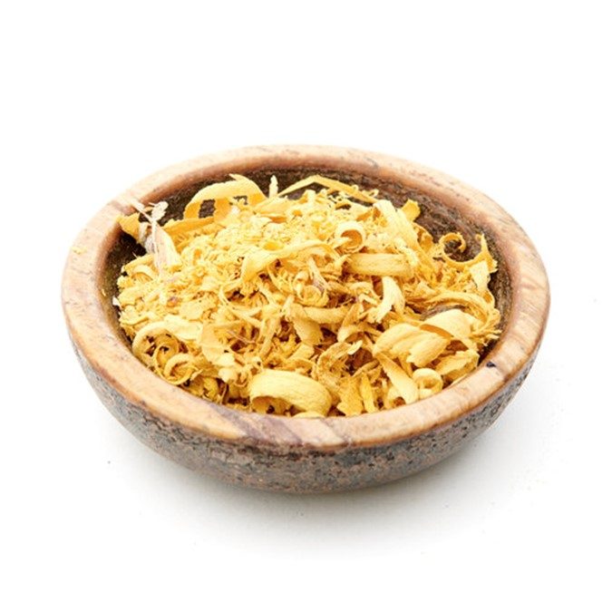 yellow shredded bark of an Osage orange in a wooden bowl