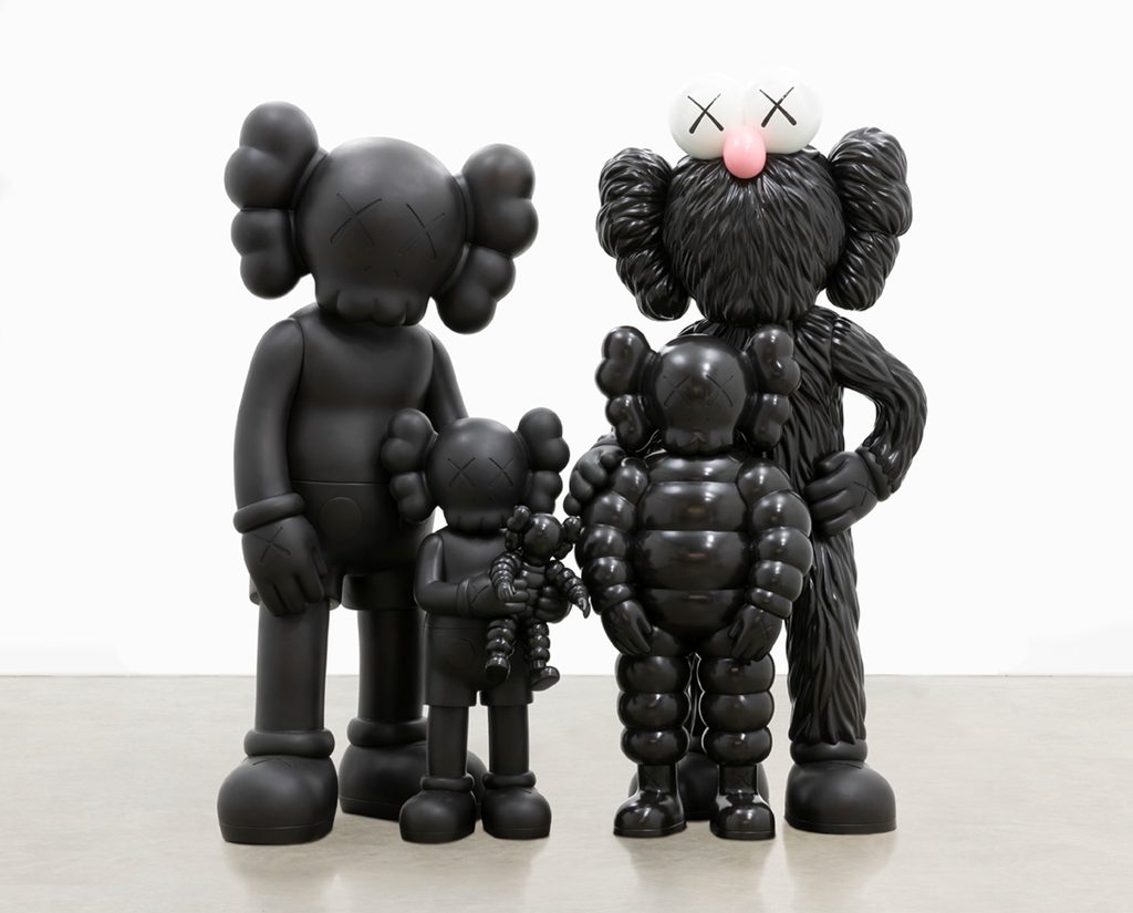 Four black sculptures depicting a family by the artist KAWS.