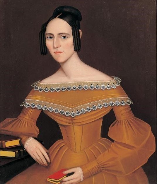 Woman in period dress with lace, holding a book; seated by table with more books, plain background.