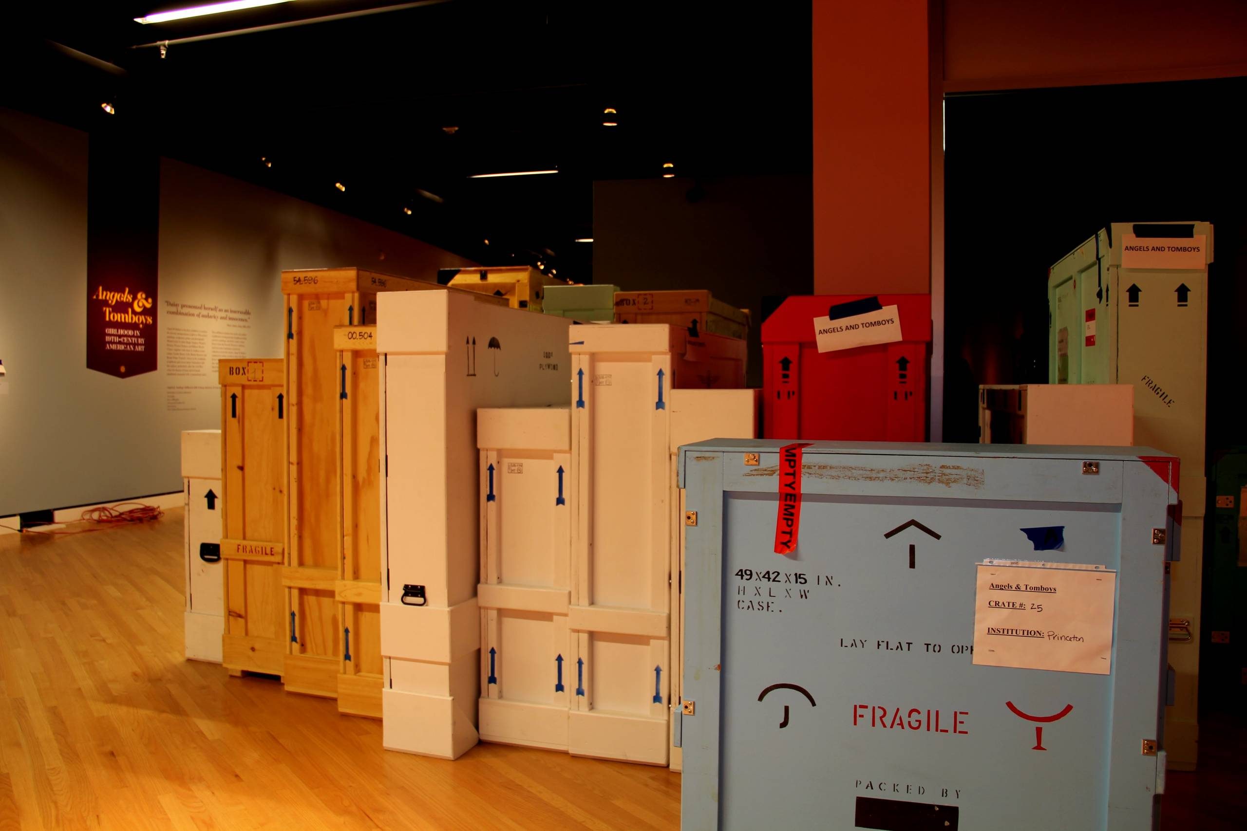 Various sized shipping crates in gallery with 