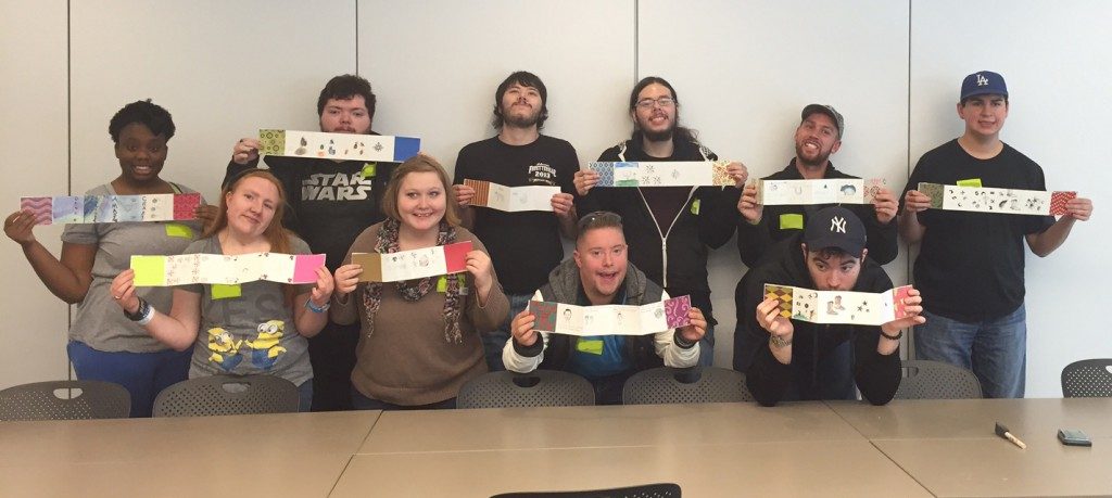 Launch students show off their completed accordion book projects.