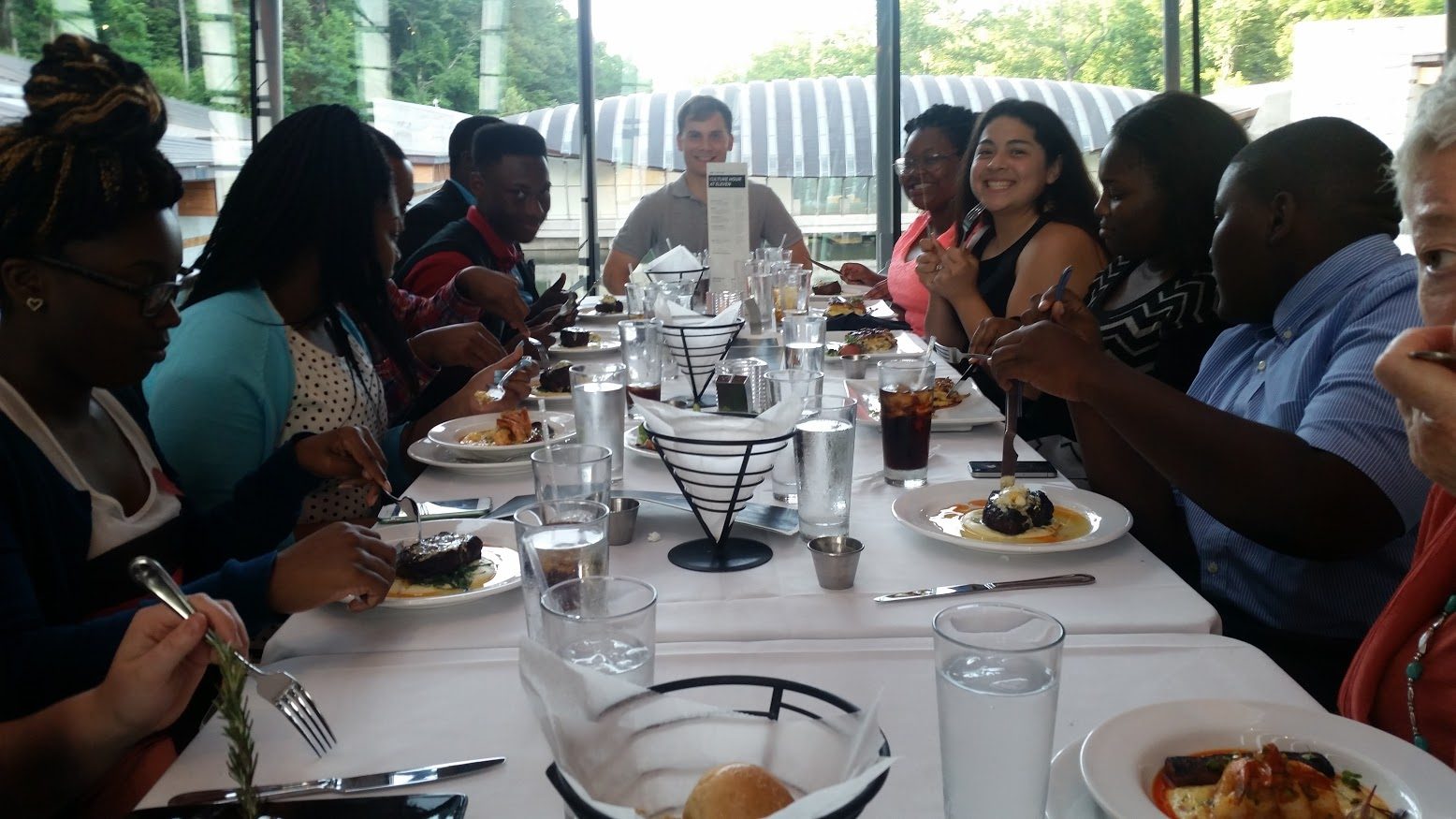 2016 high school interns share a meal together in Eleven.