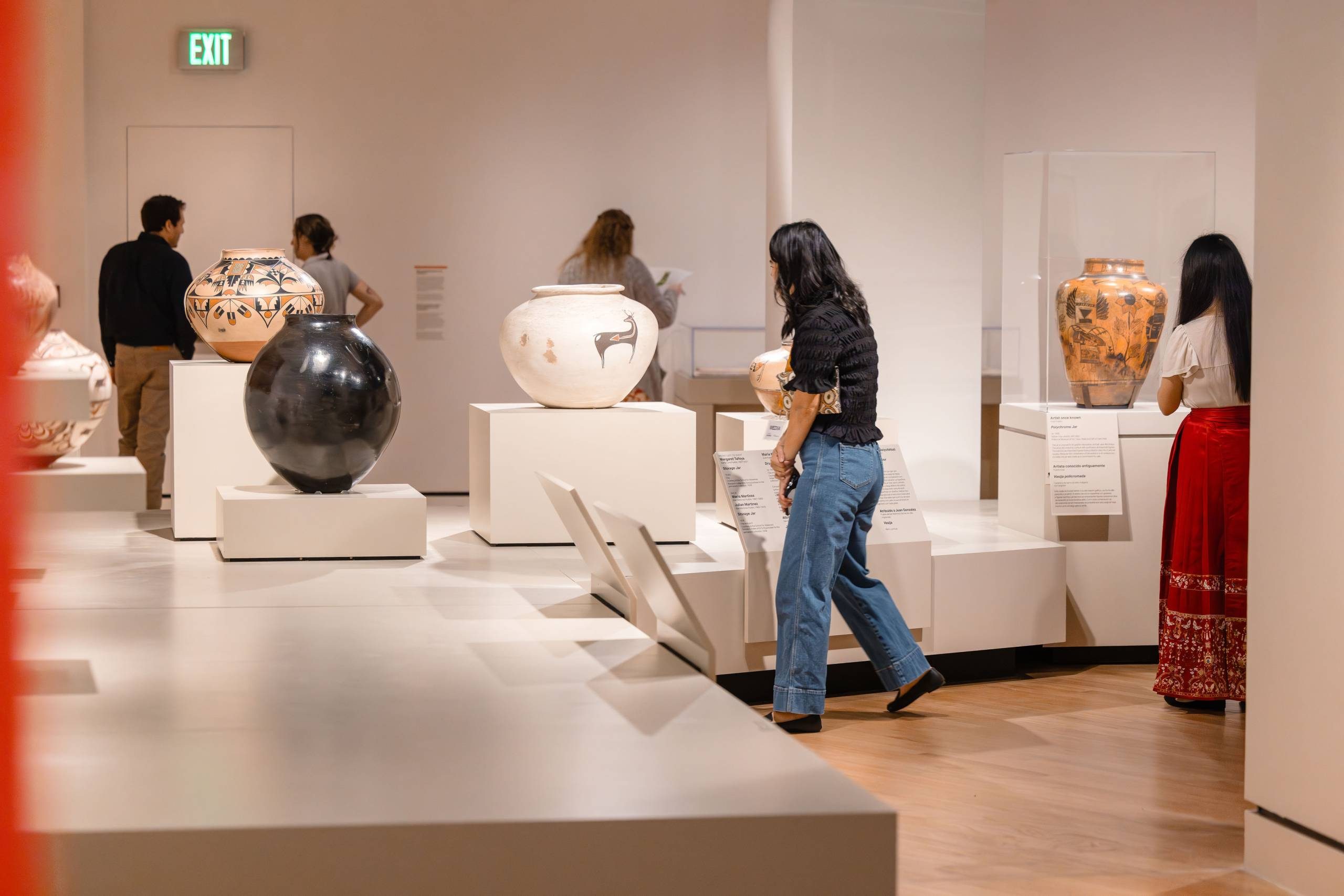 Five people view works in 'Knowing the West' at Crystal Bridges.