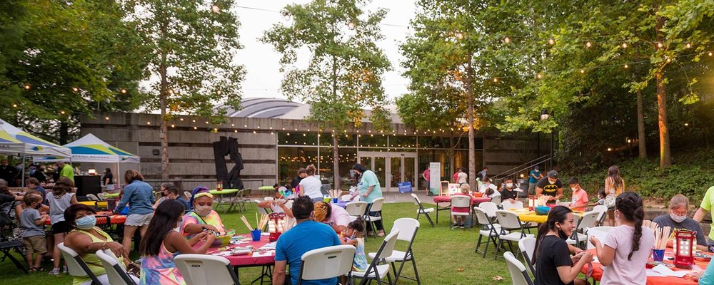 Families making art on the museum grounds