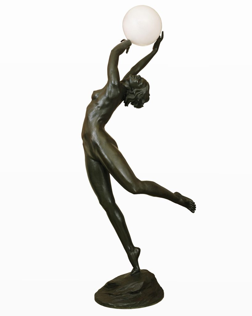 Bronze nude figure balances on one foot, reaching up to hold a glowing spherical light.