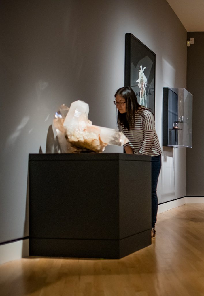 Guest looking at crystals in the gallery