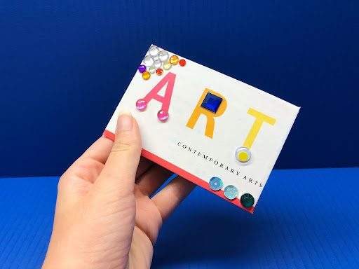 make your own sketchbook art activity; this image features a piece of scrap paper decorated with jewels