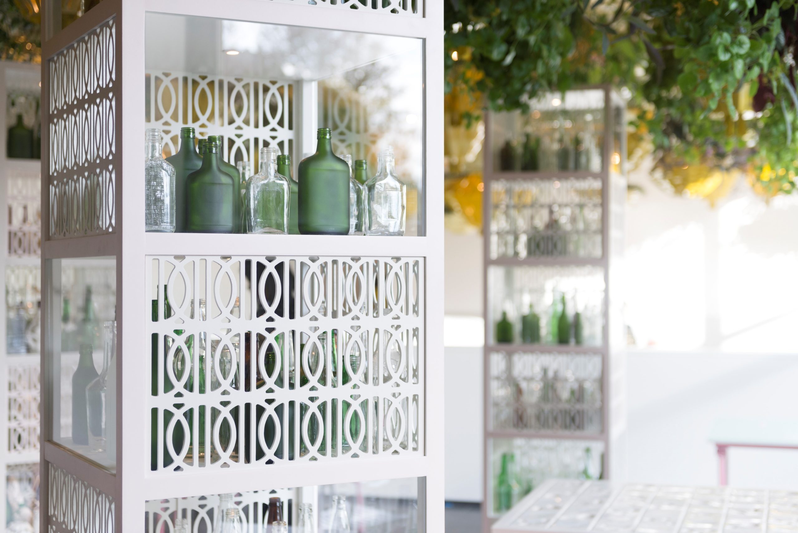 Open 24 Hours, 2017, Found glass bottles of liquor, display cabinets, 8 × 2 × 2 ft. each, Display cabinets co-designed by Navillus Woodworks, Courtesy of the artist.