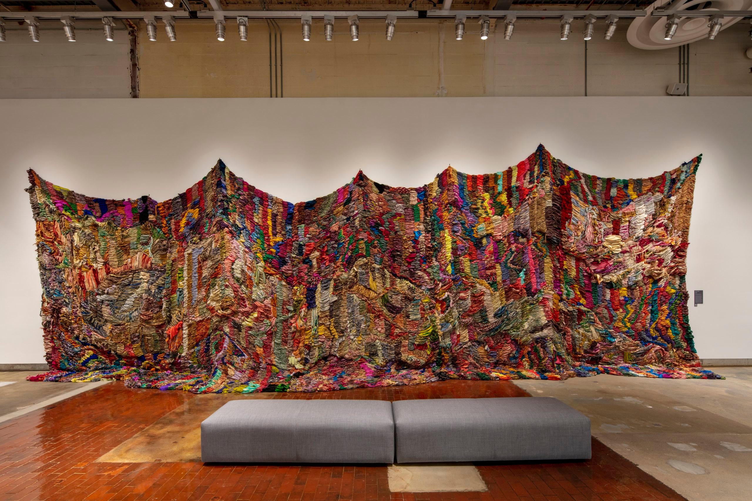 Suchitra Mattai, born 1973, Exodus, 2019, vintage saris from India; Sharjah; and artist’s Indo-Guyanese family; and rope net, 15 × 40 ft., courtesy of K Contemporary Art and the artist.