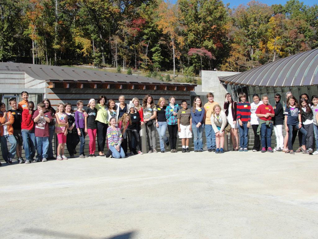 a school class poses with alice walton on walker landing